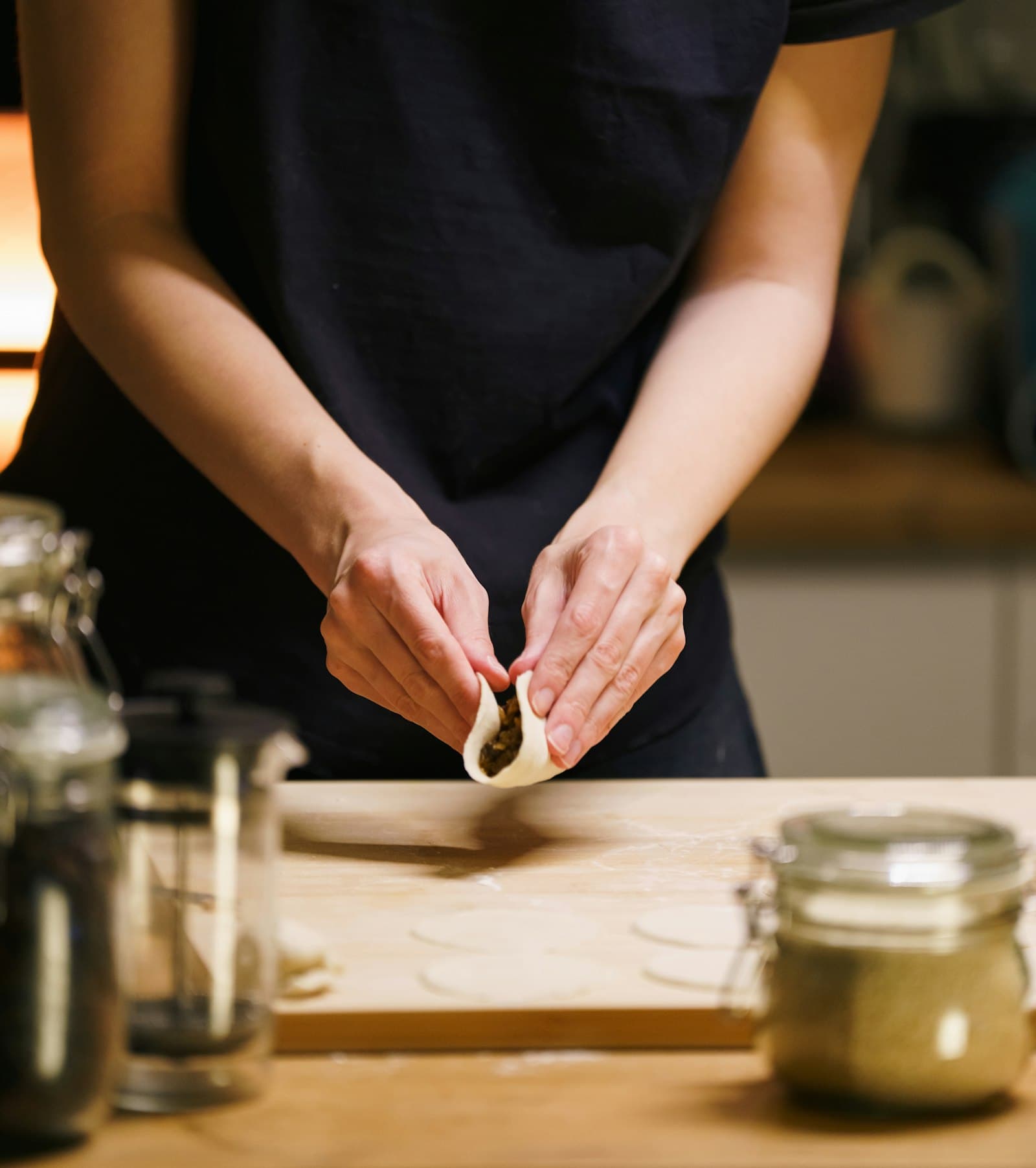 Dumplings being folded by hand
